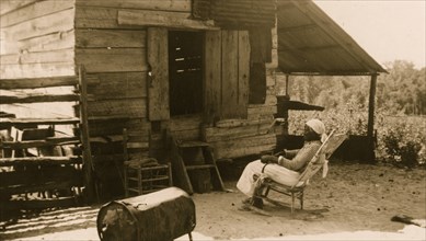 Old Aunt Julia Ann Jackson, age 102 and the corn crib where she lives 1937