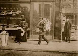 Old man carrying garments, Delancey St., N.Y 1912
