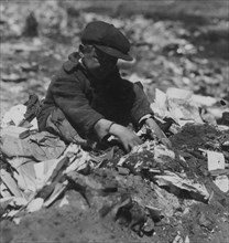 On the Pleasant Street Dump, a Young Scavenger goes through the Trash.   1916