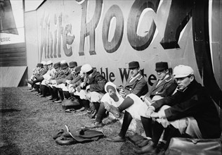 Philadelphia Americans Relax by sitting along the Center Field Fence at the Park 1908