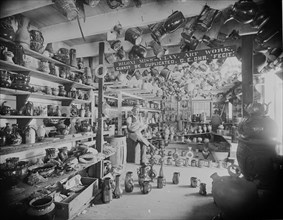 Owner sits in Retail Pottery Store waiting for Customers 1901
