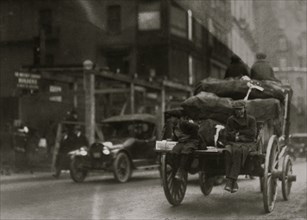 P.M. Delivery boys on Tremont Street, "getting a hitch." 1917