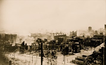 Panoramic view of the aftermath of the San Francisco earthquake and fire, showing ruins of buildings and smoke 1906