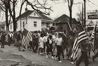 Participants, some carrying American flags, marching in the civil rights march from Selma to Montgomery, Alabama in 1965 1965