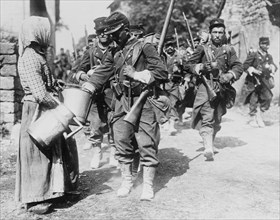 Peasant Woman provides water to passing French Troops 1918