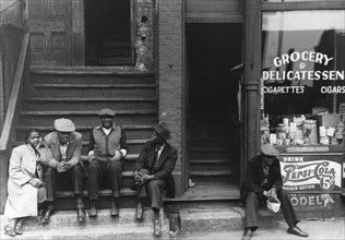 People sitting on front porches in Black section of Chicago, Illinois 1941