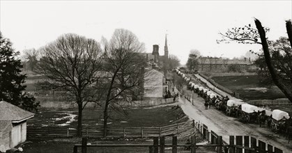 Petersburg, Virginia. The first Federal wagon train entering the town 1865