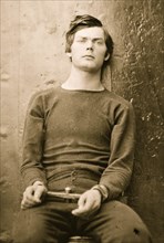 Washington Navy Yard, District of Columbia. Lewis Payne in sweater, seated and manacled 1865
