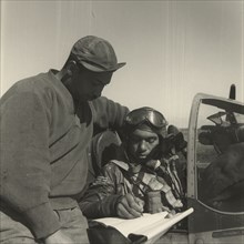 Pilot from the 332nd Fighter Group signing Form One Book 1945