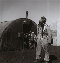Black fighter pilot series--pilot with parachute room in background, Ramitelli, Italy 1945