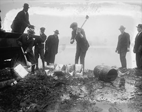 Police take axes & Picks to canisters of illegal alcohol during prohibition 1929
