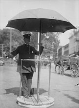 Policeman Directs traffic from underneath an umbrella in Newport, Rhode Island