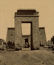Propylon (triumphal arch) and pylon in the Valley of the Rams, part of the Temple of Ramses IV in Thebes. 1880
