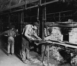 Putting Bottles into the Annealing Oven. An Indianapolis Glass Works, 1 AM 1908
