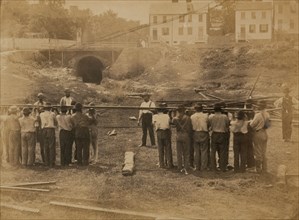Railroad construction workers straightening track 1863