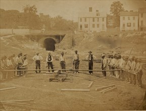 Railroad construction workers straightening track 1863