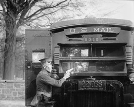 Uniformed Postal Official tests Regulation Army 44 Colt and its effect on bullet proof glass used in the new armored postal trucks 1921