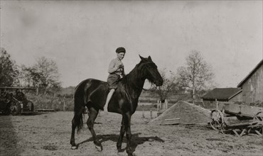 Riding a horse on the family farm 1916