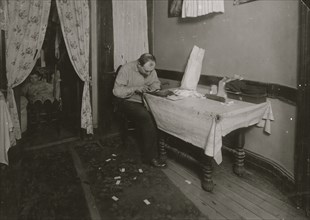 Rolling cigarette cases in tenement home. 1912