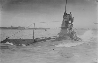 Royal Navy British Submarine A5  on Coast with Navy Men on Conning Tower above surface 1915
