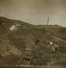 Russian supply carts at the base of a hill; on the hill, a Red Cross field post with wagons for transporting the wounded 1905