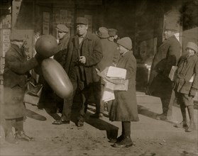 Selling balloons and handkerchiefs at market. 1917