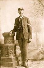 Sgt. John Denny, full-length portrait, standing, facing front 1900