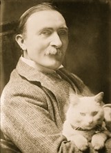 Sir Philip Burne-Jones, holding cat nown