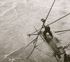 Siwash Indian fishing for salmon - pushing down the net, Fraser River, B.C., Canada 1906