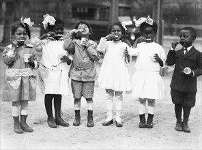 Six children brushing their teeth outside of school,  1910