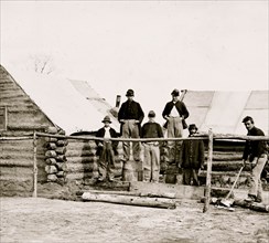 Soldier chopping wood in camp 1863