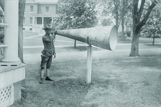 Soldier Plays his bugle into a huge megaphone at Fort Totten, Bayside Queens New York