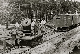 Soldiers with cannon on small railroad car 1863
