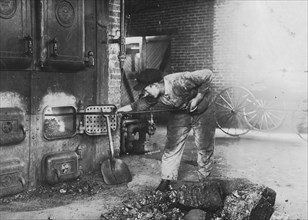 Stoking the furnace in the power-house. Pauls Valley Training School. 1917