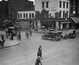 Street Corner in Washington DC in front of dye works with trucks park and growing traffic 1924