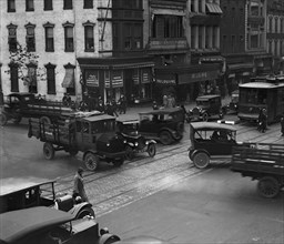 Street Corner in Washington DC with trucks park and growing traffic 1924