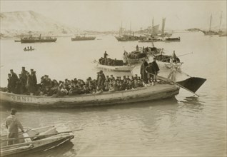 String of pontoons in tow of stream launch carrying troops 1904