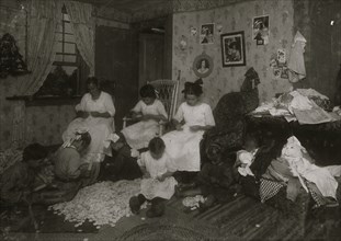 Stringing wooden buttons in a crowded home, Williamsburg,  1912