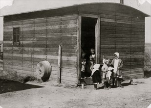 Ten-year-old Mollie Schuman left alone at the shack with all these babies and the adults far off in the field, out of sight.  1915