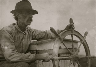 The Skipper on the Oyster Barge, Mobile Bay. Location: Bayou La Batre, Alabama. 1912