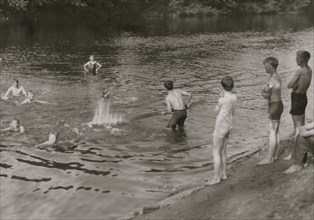 Tobacco workers take a break at a swimming hole. 1916