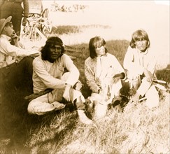 Thrasher and three Indians sitting outdoors 1901