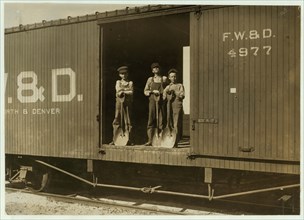 Three Boys Shoveling Zinc Ore from Car Into Wagon, 1908