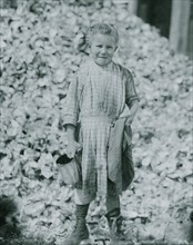 Tiny, seven year old oyster shucker (Henry's sister, No. 3291) does not go to school. Works steady. Been at it one year. Maggioni Canning Co 1912
