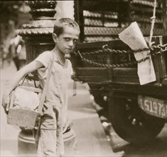 Tommie, very young shiner, Canal Street, New York City. 1924