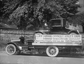 Truck carries a Chevrolet Coupe Advertisement with an actual vehicle on board 1922