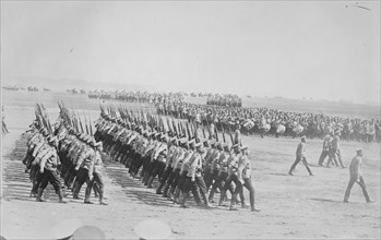 Tsarist Troops parade and pass in Review in Formation across field while a marching band plays 1907