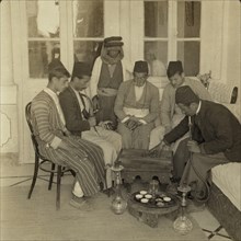 Turkish residents of Nazareth playing checkers and smoking narghiles AKA hookahs 1903