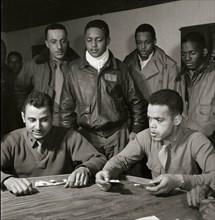 Tuskegee airmen playing cards in the officers' club in the evening 1945