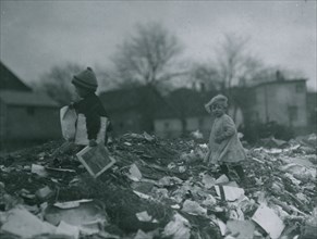 Two children going through the "Dumps." Location 1912